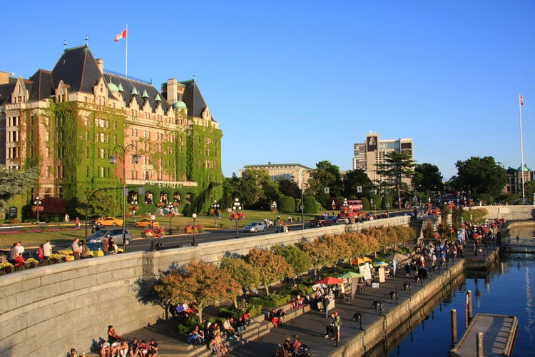 Victoria BC Inner Harbour with the Fairmont Empress Hotel, waterfront promenade, and marina activity